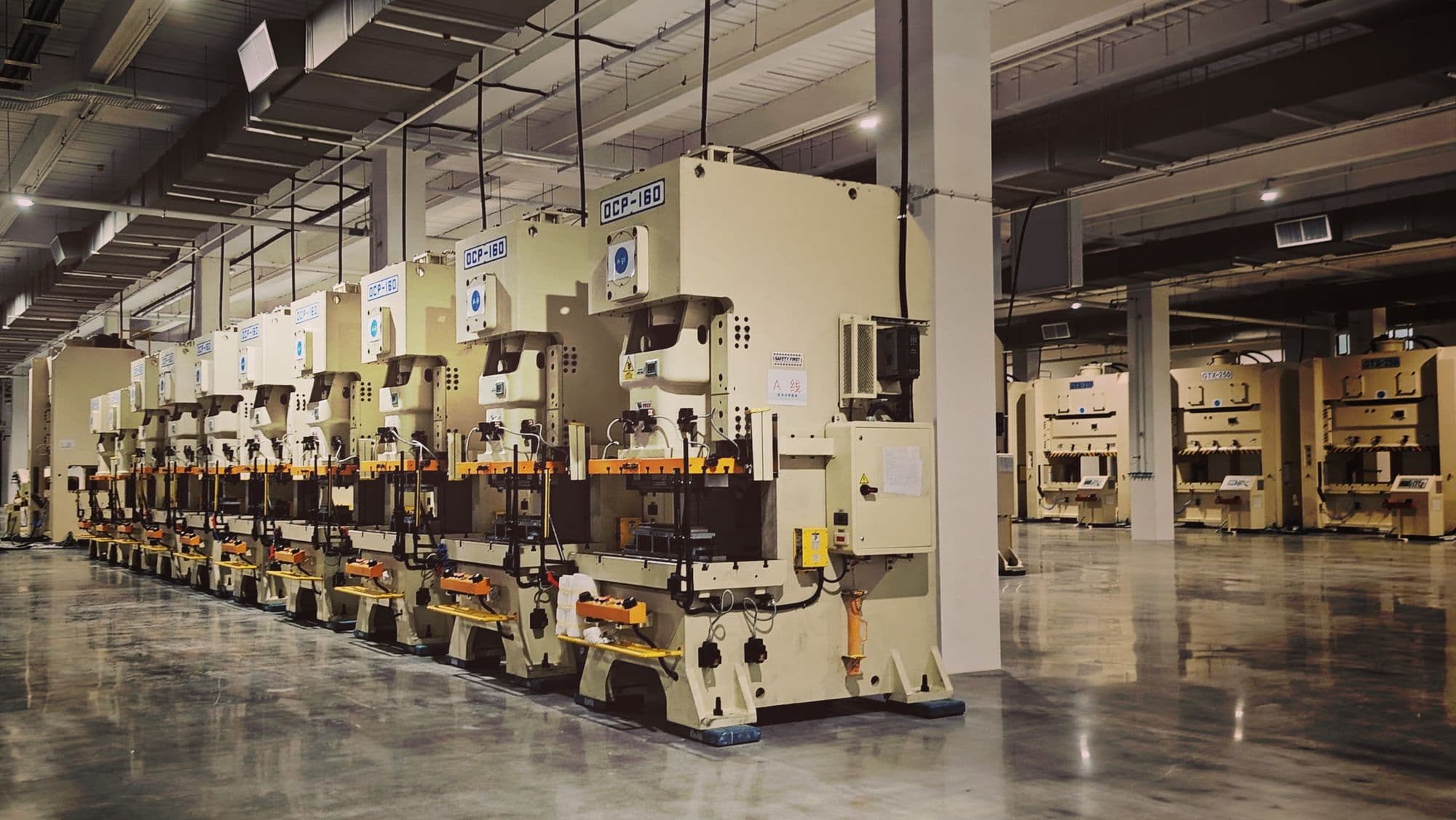 Row of precision stamping presses running on the Nexus production floor