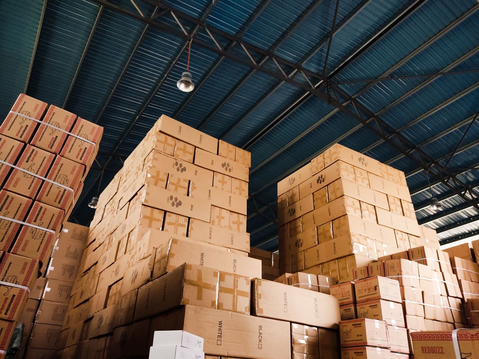 Stacked cardboard boxes filling a warehouse